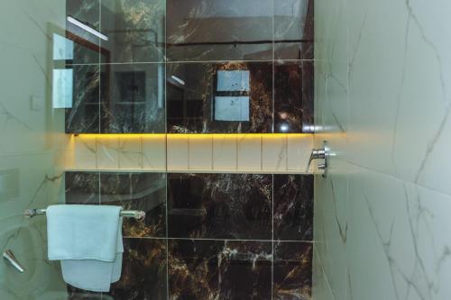 a bathroom with a glass shower with a toilet at Mira Heights in Mombasa