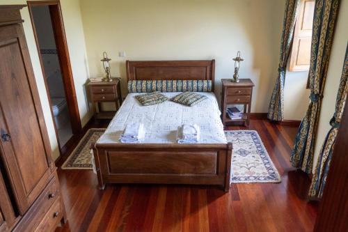 a bedroom with a bed and two night stands at 2Br Serra da Estrela Escape-Cheese & Wine Parking in Celorico da Beira