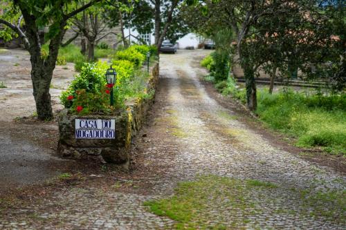 a dirt road with a sign and some flowers at 2Br Serra da Estrela Escape-Cheese & Wine Parking in Celorico da Beira