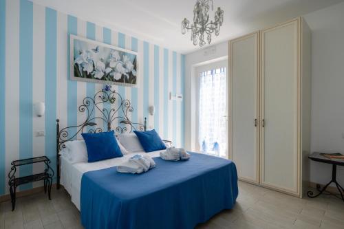 a bedroom with a blue bed with towels on it at Giglio Del Conero in Numana