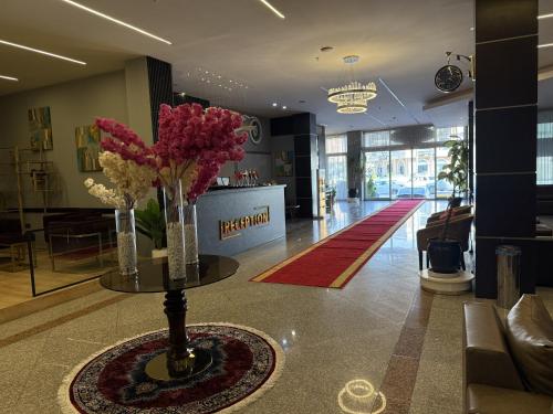 a lobby with a table with flowers on it at MyHotel Erbil in Erbil