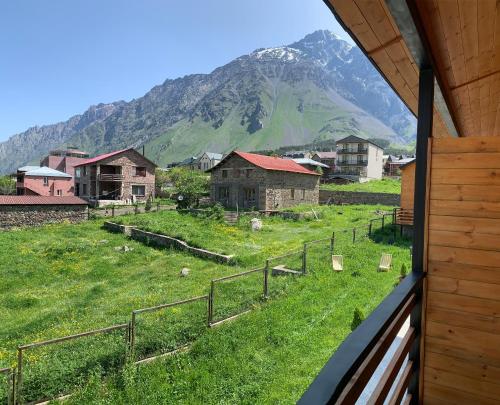 a view of a village with a mountain in the background at Mountain View in Stepantsminda
