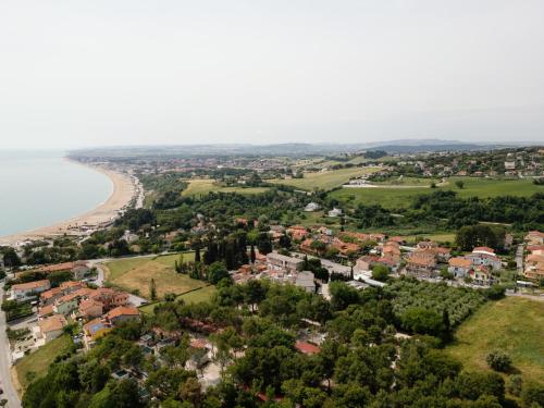 an aerial view of a town and the beach at Giglio Del Conero in Numana