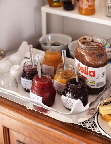 a shelf with jars of jam and other food items at Giglio Del Conero in Numana