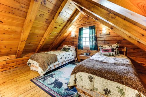 two beds in a room in a log cabin at 35 Mi to Acadia Rustic Retreat in Orland! in Orland