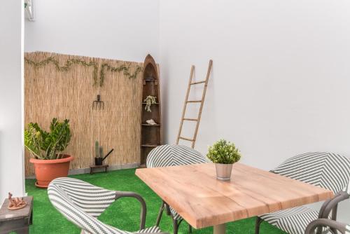 a room with a wooden table and chairs at Home2Book Bright Retreat with Roof Access in Vecindario