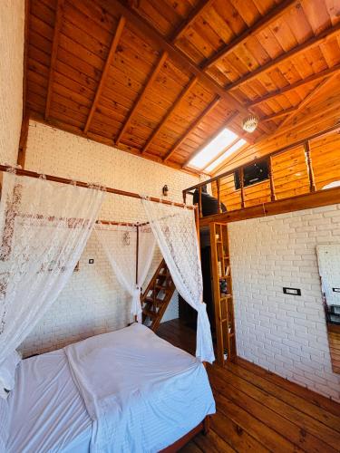 a bedroom with a bed with a mosquito net at Panchwati Farms Homestay in Almora