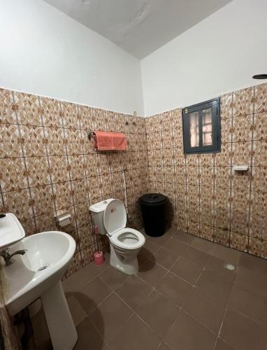a bathroom with a toilet and a sink at My stay in Yaoundé
