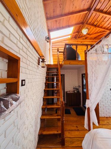 a room with a staircase leading to a loft at Panchwati Farms Homestay in Almora