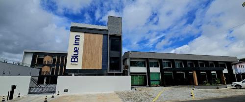 a building with a sign on the side of it at Blue Inn Hotel in Boa Vista
