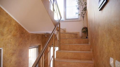 a spiral staircase in a house with a window at Pamir Guest House in Shipkovo
