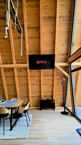 a meeting room with a sign on the wall at Old Nut Cabin in Teşila