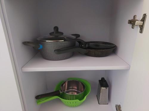 a kitchen shelf with a pot and a sink at Dreams Palace in Perea