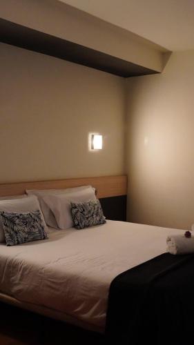 a bed with two pillows on it in a room at Hotel Marisqueria Cal Tet in L'Estartit
