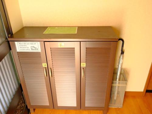 a cabinet with three doors in a room at 一间民宿 in Wada