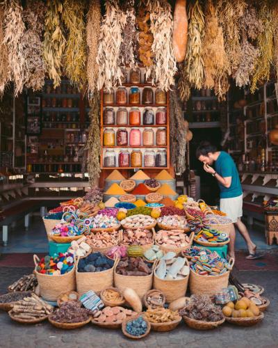 a man standing in front of a display of food at Desert Soul Camp in Erfoud