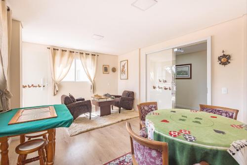 a living room with a table and chairs at Kaliman Pousada Campos do Jordão in Campos do Jordão