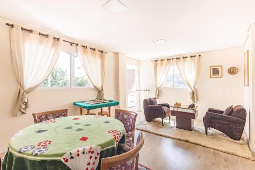 a dining room with a table and chairs at Kaliman Pousada Campos do Jordão in Campos do Jordão