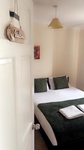 a bedroom with a bed with a black blanket at Gravesend Guest Retreat in Gravesend