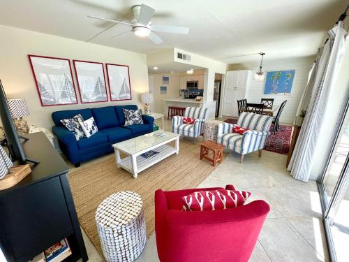 a living room with a blue couch and chairs at Sanibel Siesta on the Beach in Sanibel