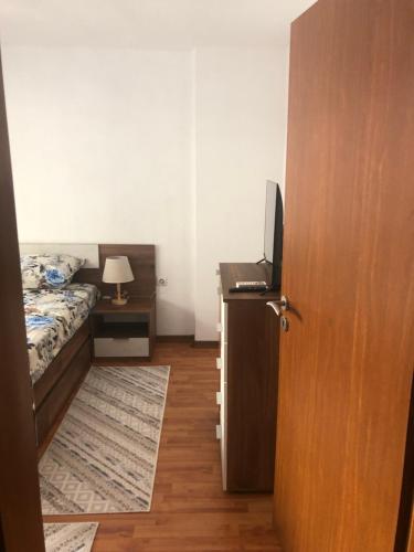 a bedroom with a bed and a desk with a television at Bety in Sandanski