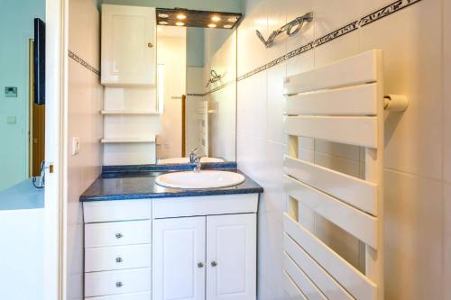 a bathroom with a sink and a mirror at Villa Repose by Villa Plus in Argeliers