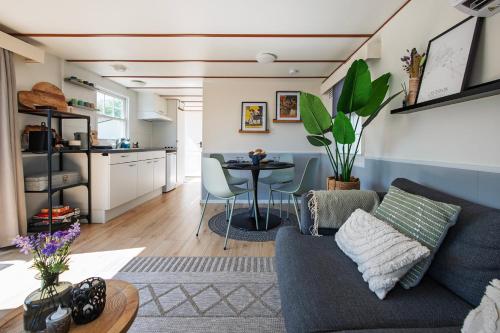 a living room with a couch and a table at 27, Beekse Bergen, Efteling, Woods, Private Parking! in Oisterwijk