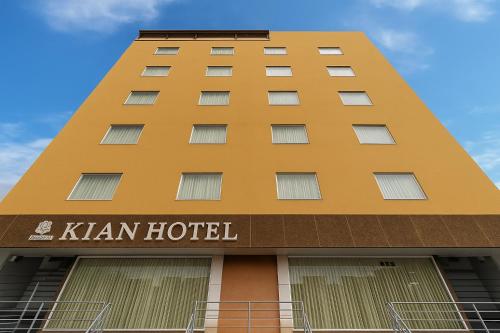 a yellow hotel building with the words khan hotel at Hotel Kian by JMD Group in New Delhi