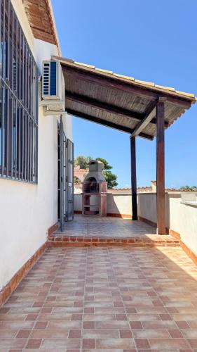 an outdoor patio with a grill on the side of a building at Appartamento Cinisi in Cinisi