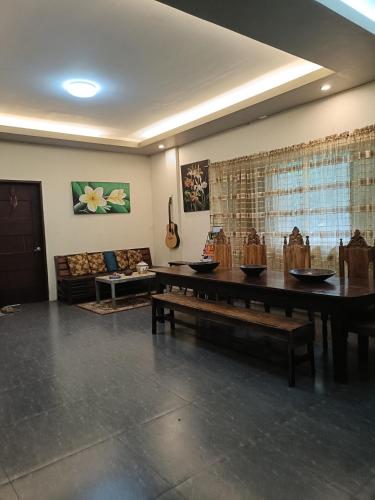 a living room with a table and a couch at Road3 B&B in Puerto Princesa