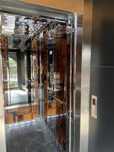 a large glass elevator in a room at Hotel Dion Kukes in Kukës