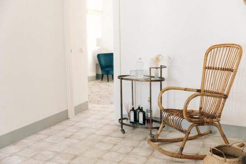 a hallway with a rocking chair and a table at Palais Gentile Matino in Matino