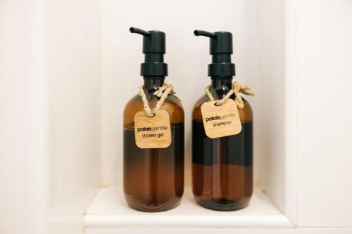 two bottles of wine on a shelf with tags on them at Palais Gentile Matino in Matino