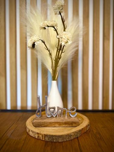 a vase with flowers in it sitting on a table at Bezdroża Mazurskie in Mrągowo