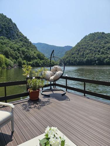 a deck with a view of a body of water at Casa Golful Mraconiei Eselnita in Eşelniţa