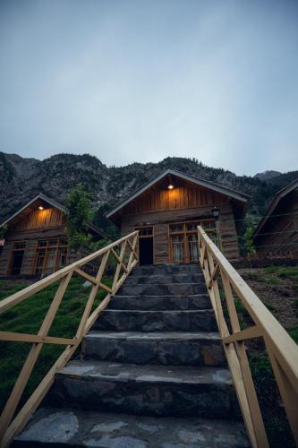 a stairway leading up to a wooden cabin with a building at Azure Lagoon Resort 