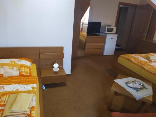 a hotel room with two beds and a mirror at Penzion SIESTA in Příbor