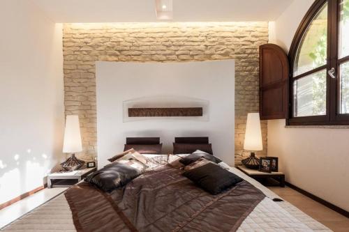 a bedroom with a large bed with two lamps at Beautiful luxury villa located in Sardinia in Villasimius near the beaches in Gesturi