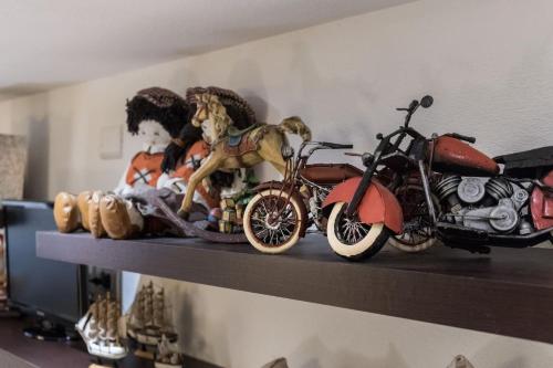 a shelf with a motorcycle and figurines on it at Beautiful luxury villa located in Sardinia in Villasimius near the beaches in Gesturi