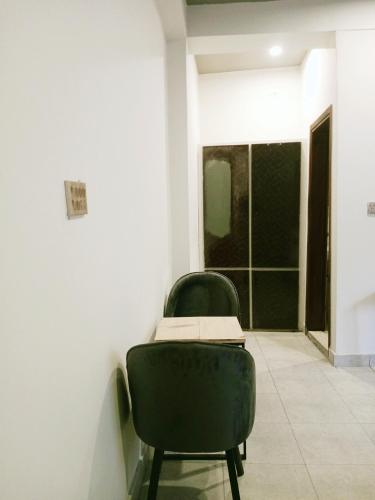 a room with a chair with a book on it at Bela Resorts Naran in Nārān