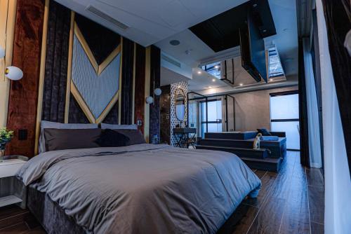 a bedroom with a large bed and a living room at 2401 at Mercury by AURA in St. Julianʼs