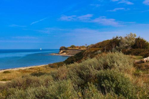 a view of the ocean from a beach at Ferienwohnung Schatzkiste in Dranske