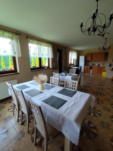 a dining room with a white table and chairs at Penzion Mystery in Vyšné Ružbachy