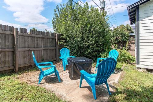 three blue chairs sitting in a yard next to a fence at Lovely family home in Northglenn with fenced yard and bonus room in Northglenn