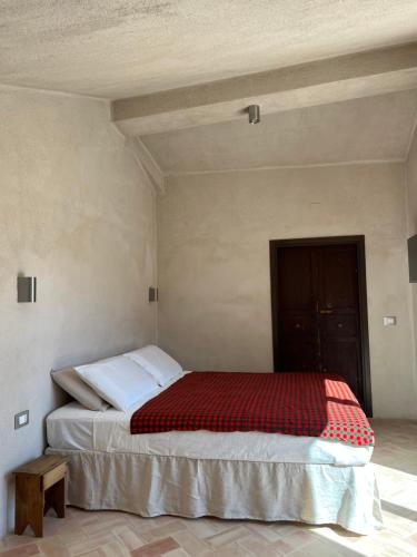 a bedroom with a bed with a red and white blanket at Agatirso in Capo dʼOrlando
