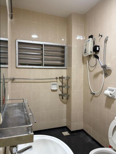 a bathroom with a sink and a toilet at Putra Impiana Puchong in Puchong