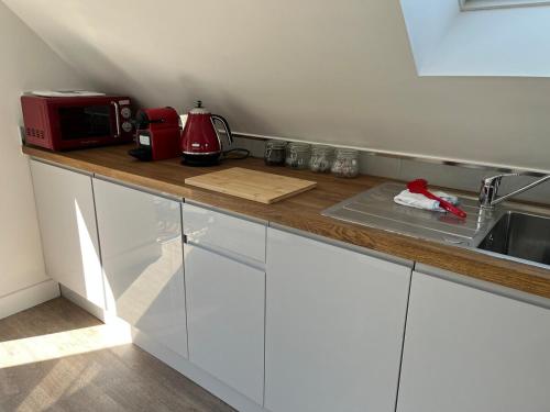a kitchen with a counter top with a microwave at Rubys cartlodge in Stambourne