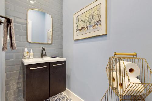a bathroom with a sink and a mirror at Oak Street Beach House in New Buffalo