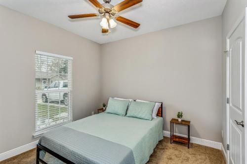 a bedroom with a bed and a ceiling fan at Lovely Townhome in Pensacola - Cozy & Modern Retreat in Pensacola