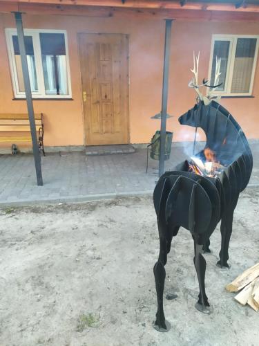 a statue of a cow standing in front of a building at Лукі in Svityazʼ